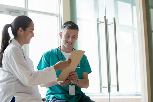 istock Doctor and Nurse reading patient chart togther 1353699559
