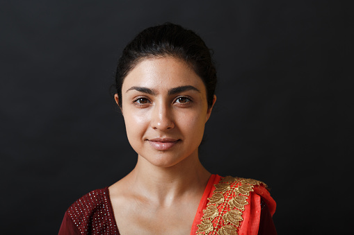 Portrait of young adult indian woman in sari.