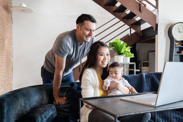 istock Smiling Family On a Video Conference Call 1353699702