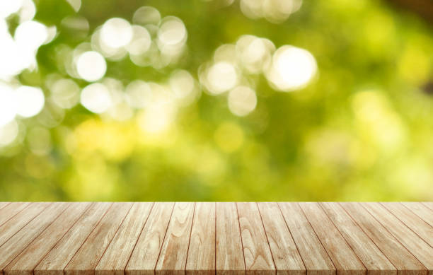 istock Empty wooden table on nature forest blurred background, assembly, product display. 1353702633