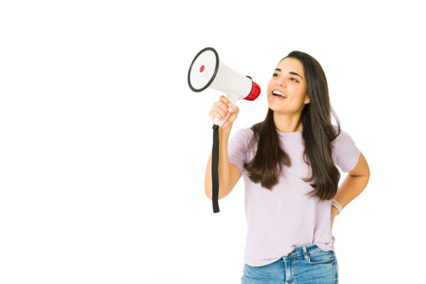 istock Young woman screaming with a megaphone 1353704810