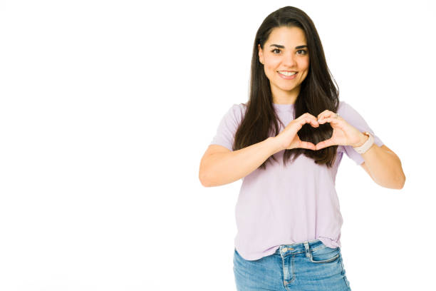 istock Adorable woman making a heart sign 1353704926