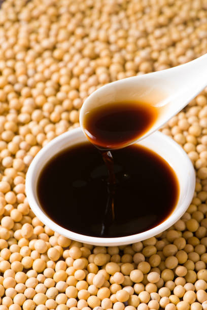 istock bowl of soy sauce on soybean background 1353705864