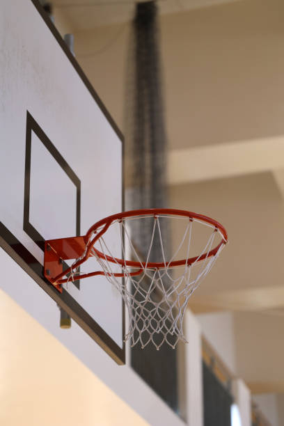 istock Gymnasium basketball ring and backboard 1353708656