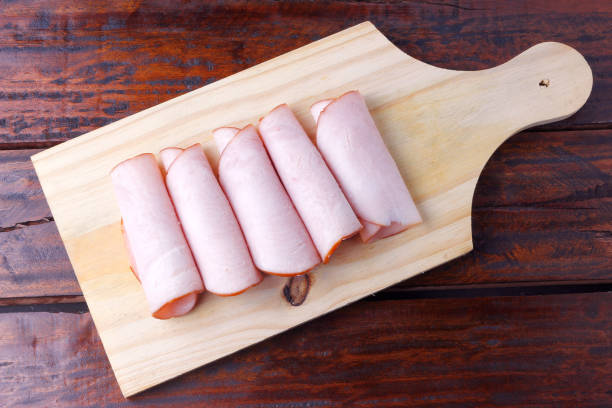 sliced cold smoked turkey breast over rustic wooden table. sliced cold smoked turkey breast over rustic wooden table. top view turkey breast stock pictures, royalty-free photos & images