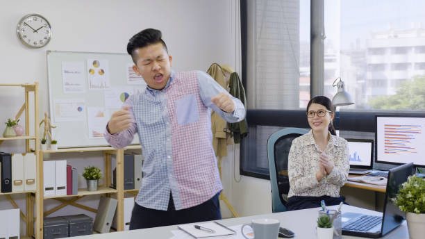 istock man worker dancing in office by colleagues. 1353713162