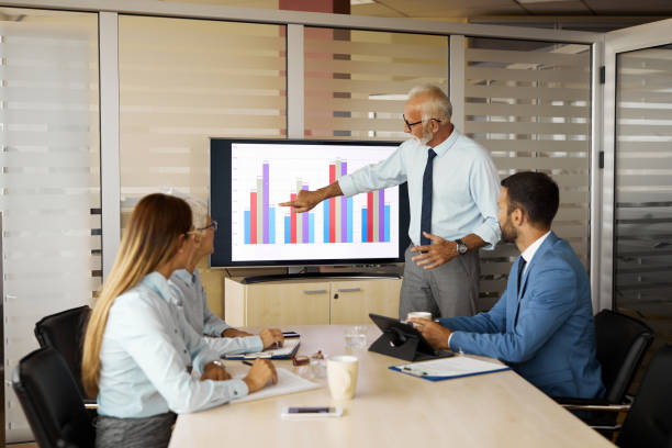 istock Senior businessman presenting business development in a meeting 1353714281