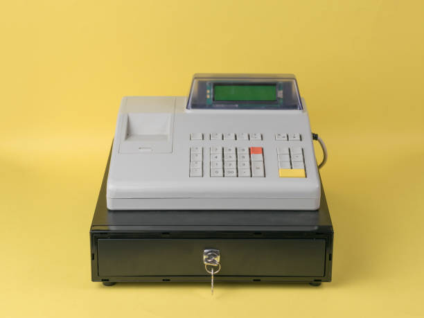 istock Cash register close-up on a yellow background. 1353716963