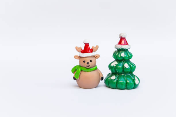 Cute little reindeer doll with Christmas tree isolate on white background, Christmas decoration item