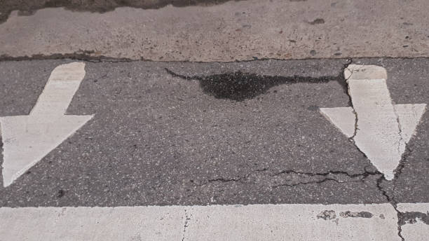 istock white arrow sign on the asphalt road 1353728004