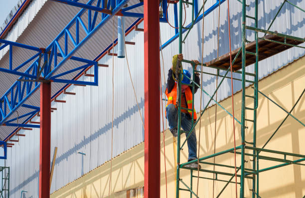 istock construction worker with safety workwear climbing on scaffolding for working on roof structure of warehouse building in construction site 1353729535