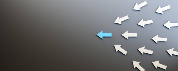 istock Leadership concept, blue leader arrow leading white arrows, on black background with empty copy space on left side 1353731823