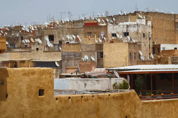 Photo of View of the old buildings roofs in medina quarter of Fez in Morocco. The medina of Fez is listed as a World Heritage Site and is believed to be one of the world largest urban pedestrian zones.