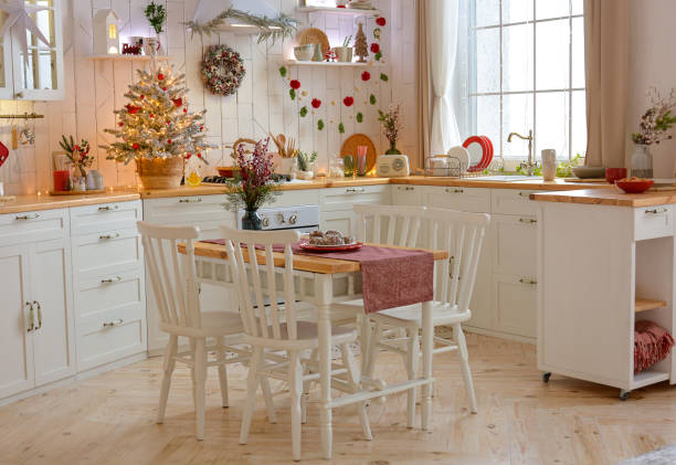 istock Interior of a light white ?hristmas kitchen with red decor elements in the Scandinavian style. Christmas decorations. Breakfast 1353736176