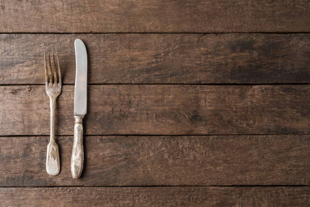 istock Rustic cutlery on wooden table. Food background 1353739469