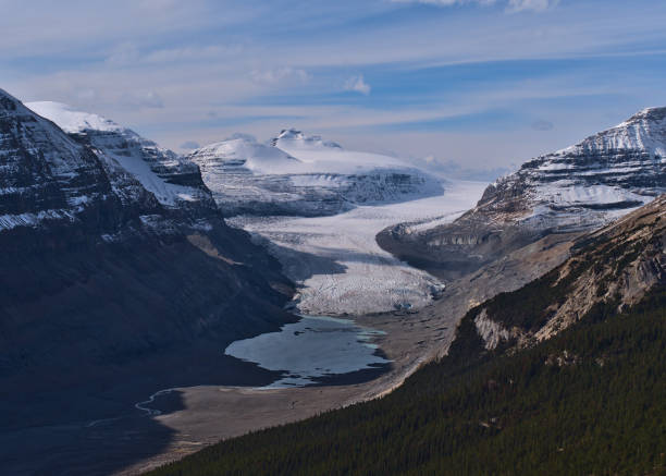 Beautiful view of big Saskatchewan Glacier, part of Columbia Icefield, in Banff National Park, Canada in the Canadian Rockies in valley with glacial lagoon in autumn. Beautiful view of big Saskatchewan Glacier, part of Columbia Icefield, in Banff National Park, Alberta, Canada in the Canadian Rockies in valley with glacial lagoon in autumn season. saskatchewan glacier stock pictures, royalty-free photos & images