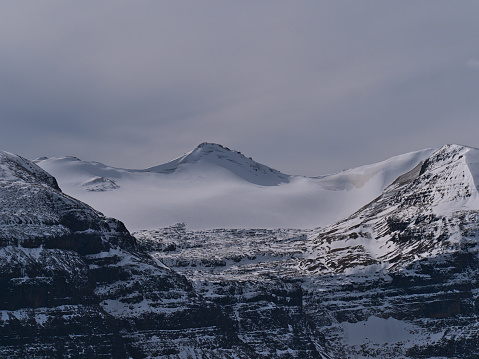 View of ice-capped mountain Big Bend Peak viewed from Parker Ridge in Banff National Park, Alberta, Canada in the Rocky Mountains, part of Columbia Icefield, on cloudy day in autumn.