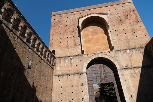 Porta Ovile, Imposing city gate from the 13th century with a curved arch and battlements, Siena, Tuscany, Italy 10.07.2021