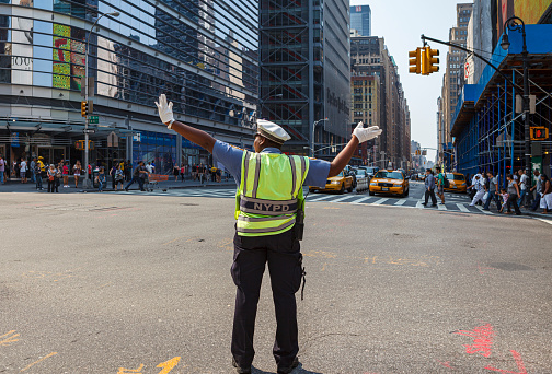 New York, USA - September 4, 2011: NYPD traffic enforcement agent performs work on 8th avenue at 42nd street,  Midtown Manhattan, NY