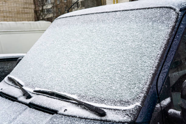 istock The car, covered with thick layer of snow. Negative consequence of heavy snowfalls. Close-up shot of a car's windscreen wiper covered in snow 1353742599