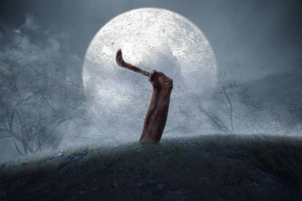 istock Zombie hand with blood and wound holding sickle raised 1353742781