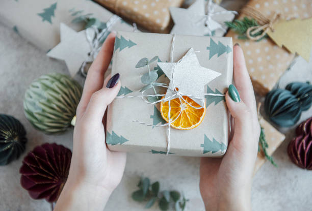 istock Woman giving a Christmas  gift 1353744995