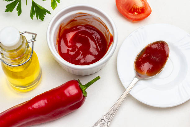 istock Red pepper pod, tomato wedge and olive oil. 1353747288