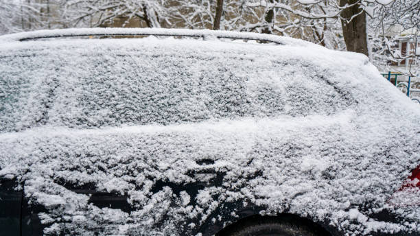 istock The car, covered with thick layer of snow. Negative consequence of heavy snowfalls. Side hundred cars with different patterns. 1353747294