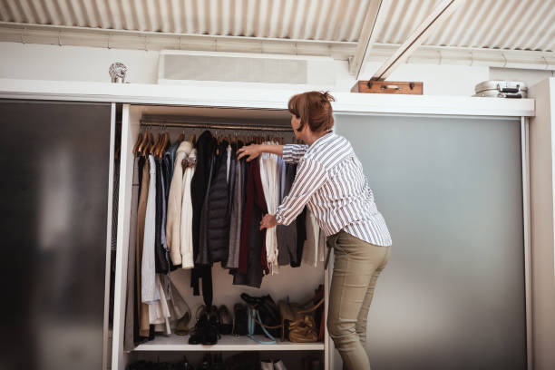 istock Senior female preparing and packing suitcase for a vacation 1353750056