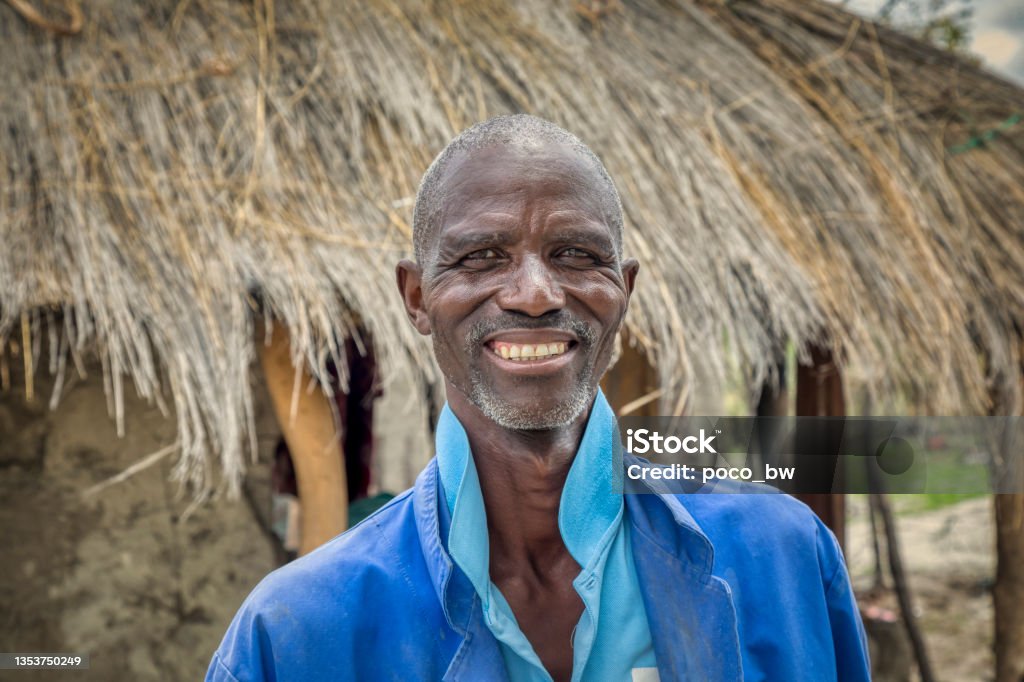 Elderly African man portrait Happy elderly African man portrait, in front of his house in an African village Men Stock Photo