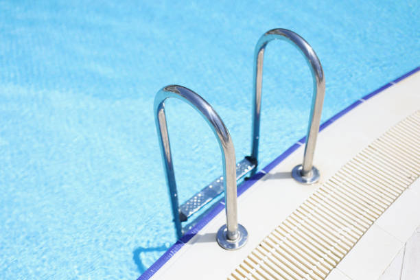 An elderly man is actively engaged in swimming and sports in the pool in a retired sports complex