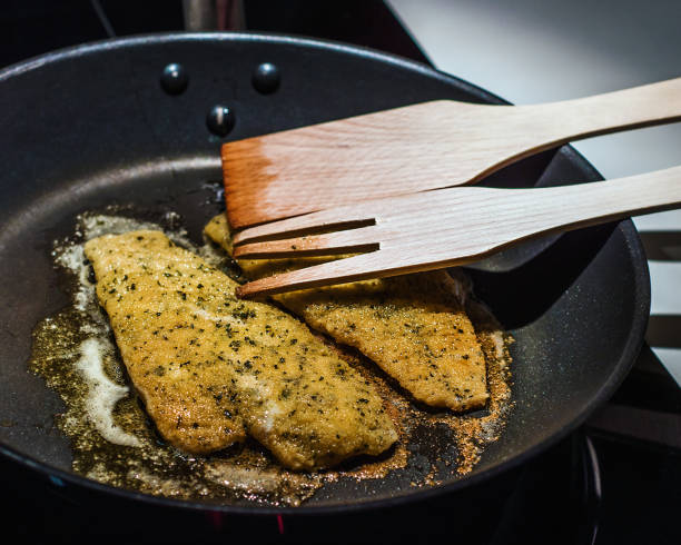 Plaice meuniere fillets being cooked in the pan