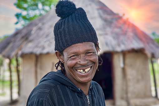 Toothless african  man portrait in the yard of his village