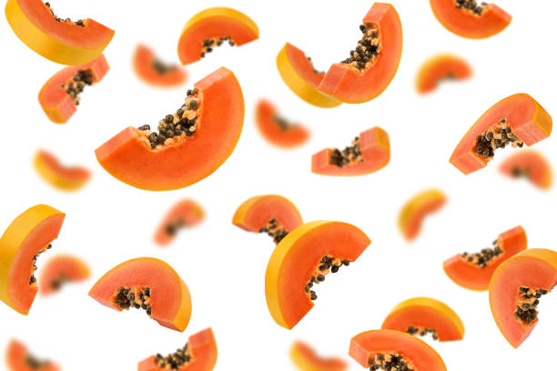 istock Falling papaya slice isolated on white background, selective focus 1353758378