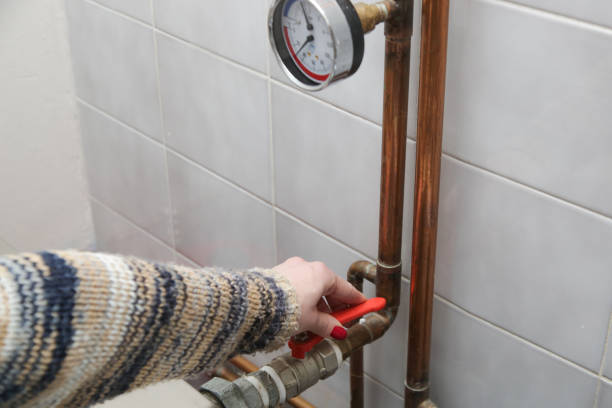 istock A part of central heating system. Woman hand adjusting valve for home heating. 1353758898