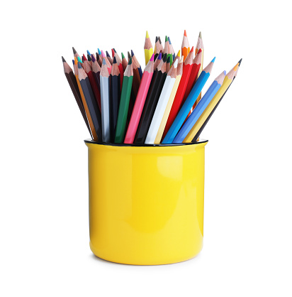 Colorful pencils in yellow mug on white background