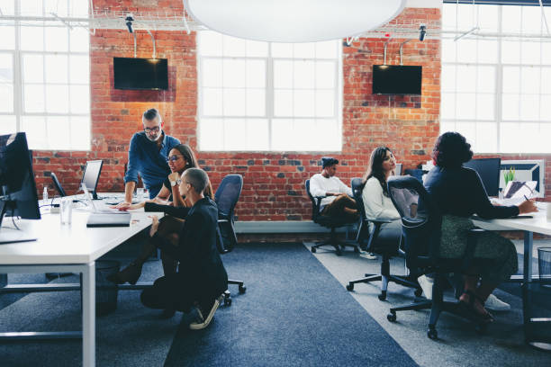 istock Group of businesspeople working in a creative modern office 1353760402