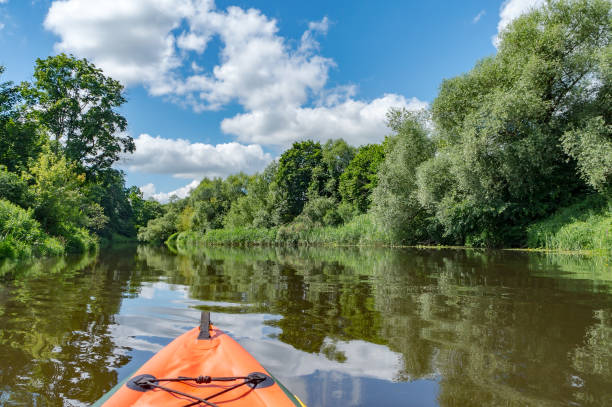 istock Canoeing on a quiet river. Journey in kayaks on the river. Active rest on the water. 1353762783