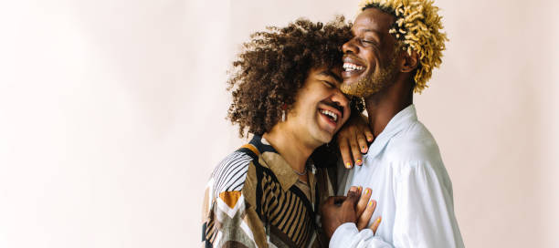istock Happy young gay couple standing in a studio 1353763526
