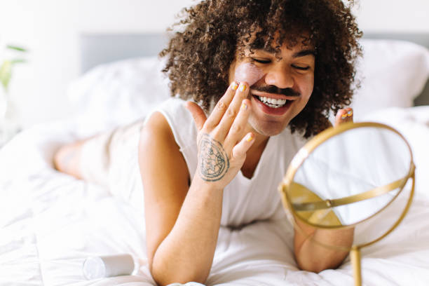 istock Nonconforming young man applying makeup to his face 1353764056