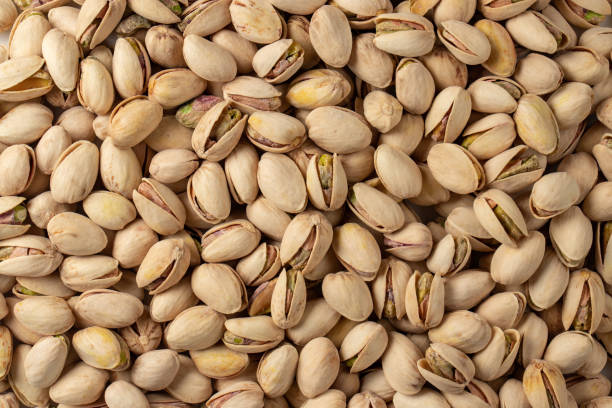 istock Pistachio texture. Nuts. Green fresh pistachios as texture. 1353764231