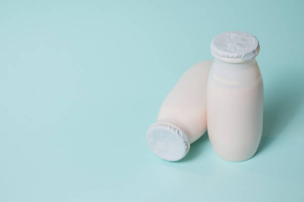 istock Bottles with probiotics and prebiotics dairy drink on light blue background. 1353764650