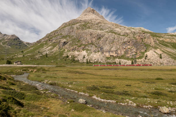istock Swiss train crossing idyllic landscape 1353765563