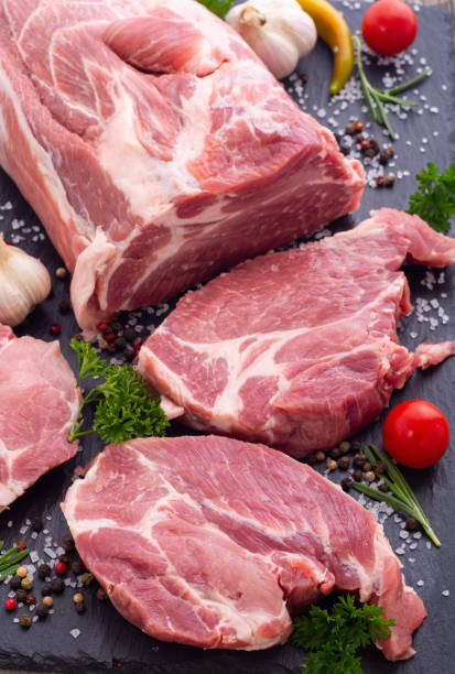 istock Raw pork neck with spices and herbs 1353765658
