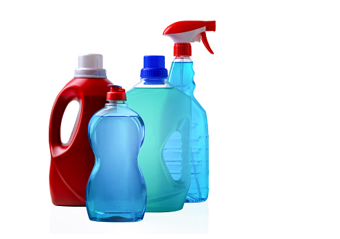 Different bottles with detergents against a white background