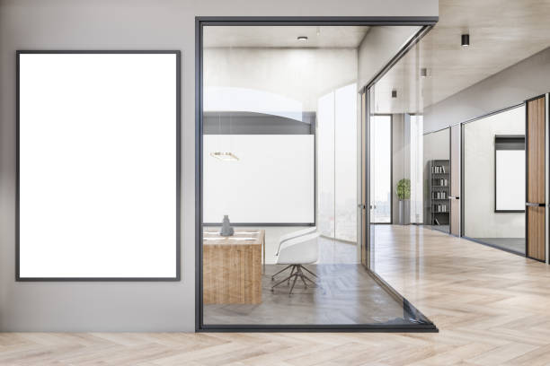 istock Modern concrete and wooden office interior corridor with empty white mock up frame on wall, glass partition and furniture, daylight, window with city view. Workplace concept. 3D Rendering. 1353767262