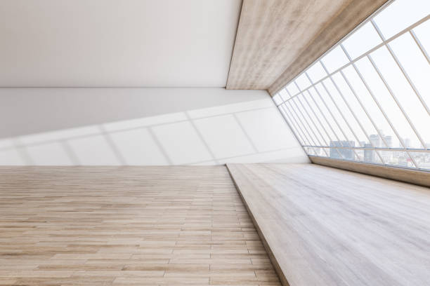 istock Modern spacious concrete interior with wooden flooring, panoramic city view and daylight. Minimalistic room concept. 3D Rendering. 1353767602