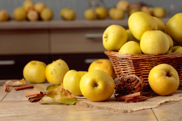 One red apple, stack of oranges on granite countertop in modern kitchen.  Healthy lifestyles.