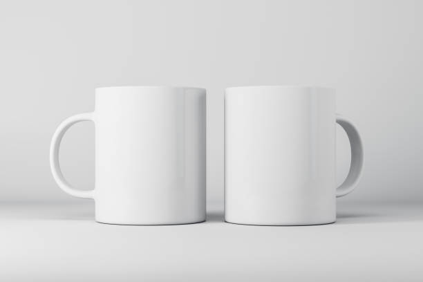 istock Two empty white mugs or cup on light background with mock up place for your advertisement. 3D Rendering. 1353767904