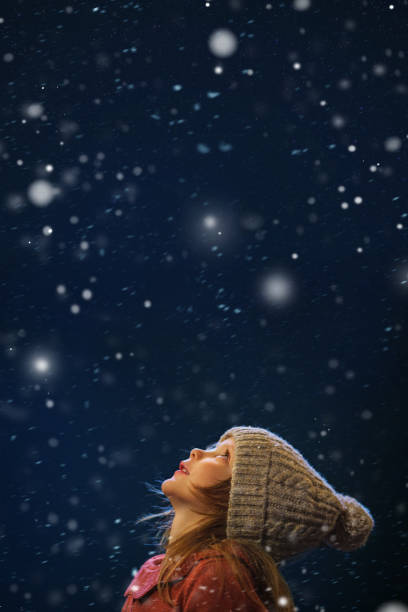 A little girl look up at christmas - childhood belief stock photo